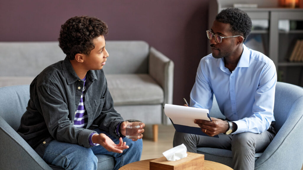 A young man talks to his therapist at adolescent psychiatry in Bend, Oregon.