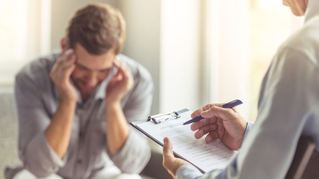 A man struggling with his mental health seeks professional support.