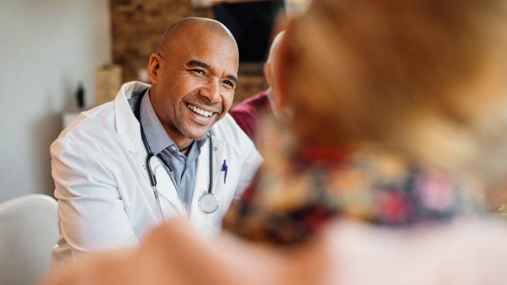 A doctor discusses buprenorphine treatment with his client during a consultation.