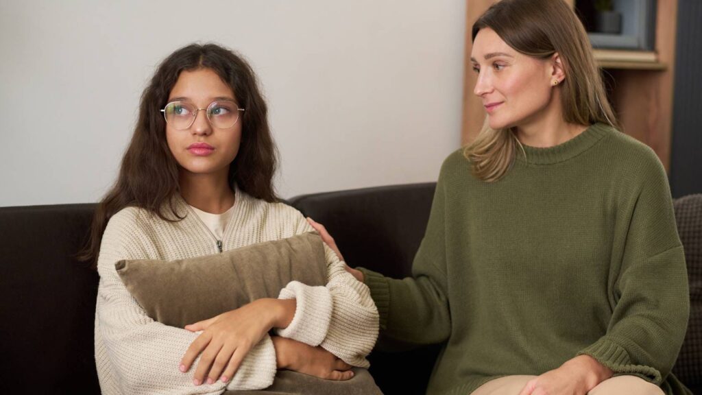 Mother supporting her teen during an appointment with a teen psychiatrist.