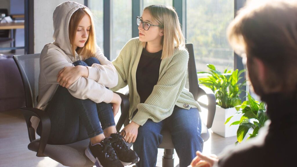 Teen psychiatrist meeting with a mother and her teenage child.