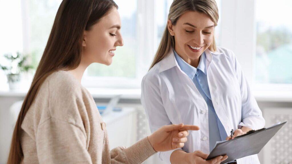 Professional advising a client on insurance matters at a Suboxone clinic.