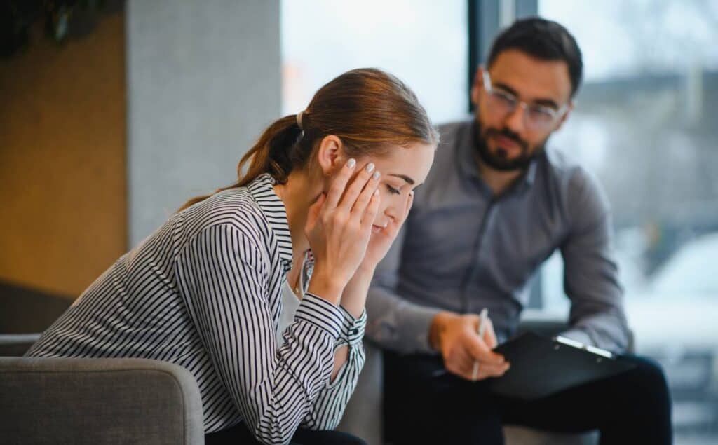 Individual therapy session focused on high-functioning anxiety with a woman looking down.