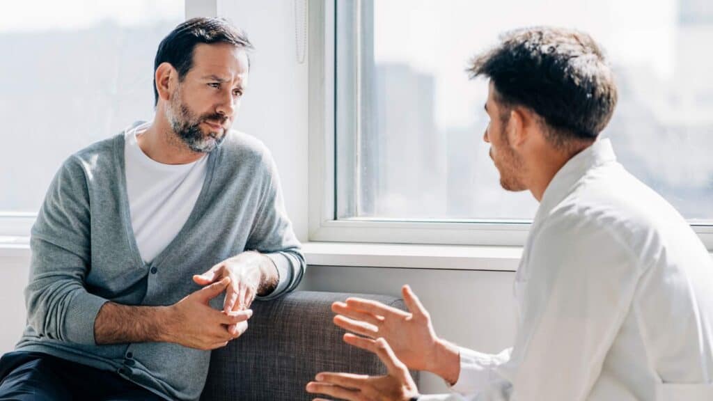 A man discussing his recovery journey with a professional counselor at Aetna Rehab in Portland